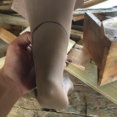 Cutting thermoformed foam insert to size for 3D printed foot abduction brace.  Lake Victoria Disability Centre | Musoma, Tanzania.  