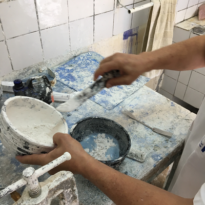 Roberto Postelmans mixing plaster to process a plaster cast.  HVP-Gatagara | Gatagara, Rwanda.  