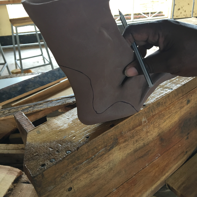 Cutting thermoformed foam insert to size for 3D printed foot abduction brace.  Lake Victoria Disability Centre | Musoma, Tanzania.  