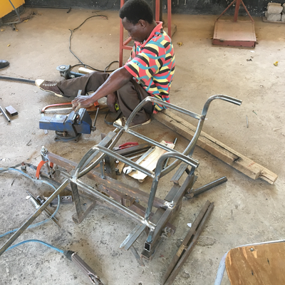 An LVDC staff member, himself disabled, welding a custom wheelchair.  Lake Victoria Disability Centre | Musoma, Tanzania.
