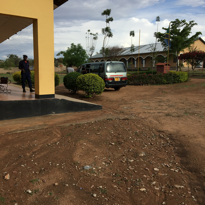 A van picks up and drops off LVDC staff members each day.  The Lake Victoria Disability Centre Campus consisted of many yellow buildings with corrugated metal roofs, all built and maintained by LVDC staff.  Lake Victoria Disability Centre | Musoma, Tanzania.