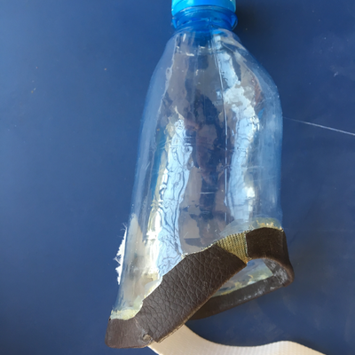 A custom prosthetic for a bilateral upper limb amputee, with a thermoformed water bottle socket and 3D printed end effector.  Lake Victoria Disability Centre | Musoma, Tanzania.  