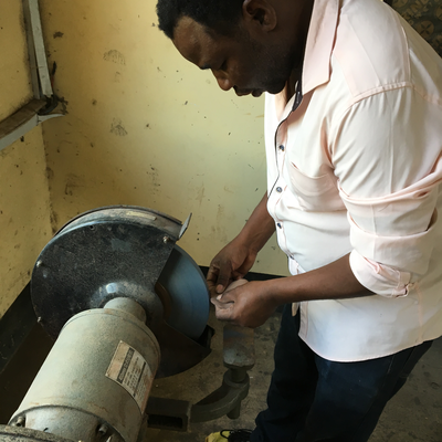 Bob, a P&O technician at LVDC, shaping a foot abduction brace soft insert with a grinder.  Lake Victoria Disability Centre | Musoma, Tanzania.