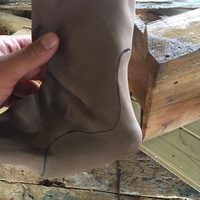 Cutting thermoformed foam insert to size for 3D printed foot abduction brace.  Lake Victoria Disability Centre | Musoma, Tanzania.  