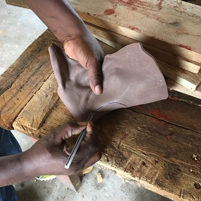 Cutting thermoformed foam insert to size for 3D printed foot abduction brace.  Lake Victoria Disability Centre | Musoma, Tanzania.  