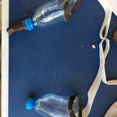 A set of custom prostheses for a bilateral upper limb amputee, with thermoformed water bottle sockets and 3D printed end effectors.  Lake Victoria Disability Centre | Musoma, Tanzania.  