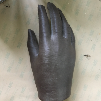 A 3D printed hand (white, Filaflex) sprayed with an Ottobock Superskin coating for cosmetic purposes.  HVP-Gatagara | Gatagara, Rwanda.  