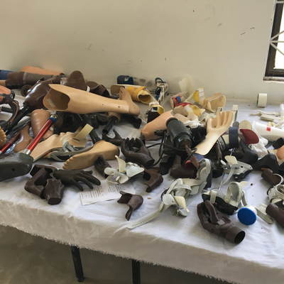 Assorted prosthetic and orthotic devices on a bench in the P&O workshop at LVDC.  Lake Victoria Disability Centre | Musoma, Tanzania.  