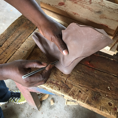 Cutting thermoformed foam insert to size for 3D printed foot abduction brace.  Lake Victoria Disability Centre | Musoma, Tanzania.  