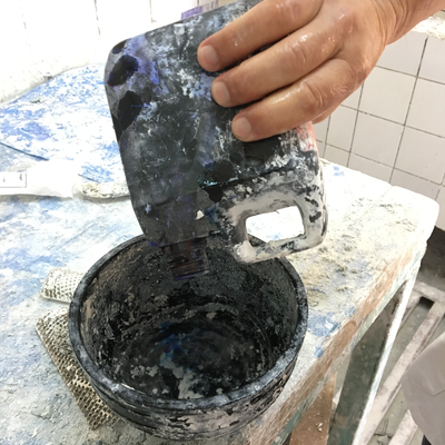 Roberto Postelmans mixing dye into plaster to process a plaster cast.  HVP-Gatagara | Gatagara, Rwanda.  
