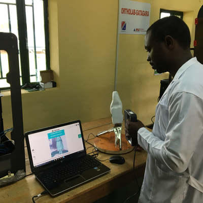 Issac Rukundo, director of the P&O department at HVP-Gatagara, 3D scanning a plaster cast.  ORTHOLAB | Gatagara, Rwanda.  